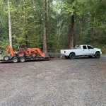 truck carrying tractor for spreading mulch in lake cassidy washington